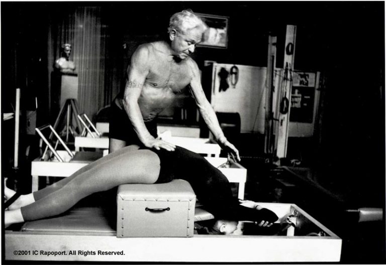 Joseph Pilates with his early apparatus 